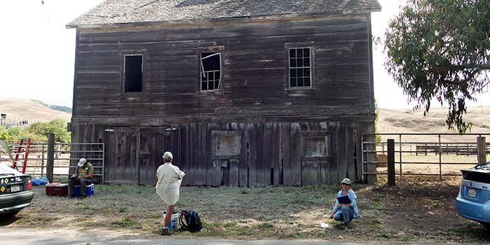 Site stewards taking notes on the condition of historic building